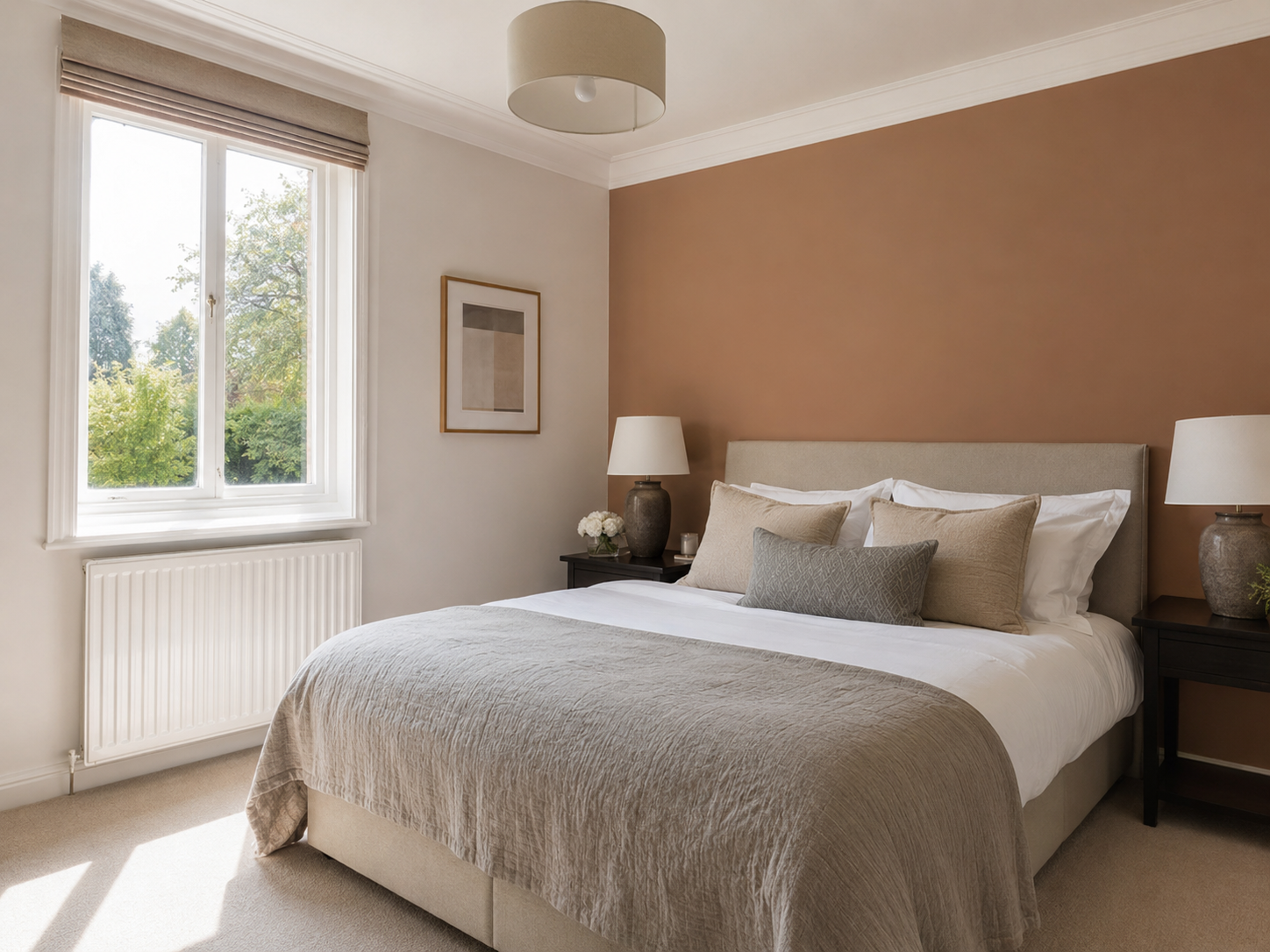 Finished bedroom with warm clay feature wall and crisp white woodwork in Chichester
